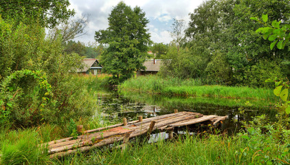 Rural landscape with river and wooden bridge