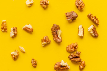 peeled walnut on yellow background isolated text design