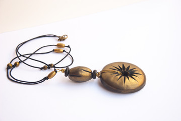 Black gold shiny boho necklace in macro. Fashion jewelry background. Handmade polymer clay  jewelry.