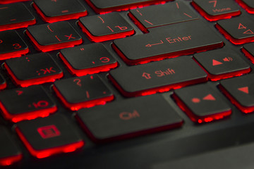 black keyboard of the game laptop with red illumination