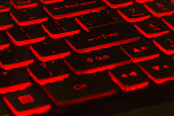 black keyboard of the game laptop with red illumination