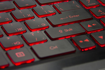 black keyboard of the game laptop with red illumination