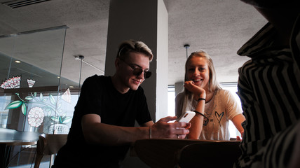 Young couple having fun in the cafe