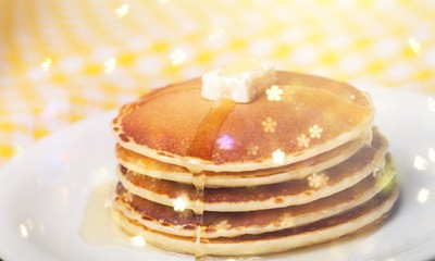 Stack of Small pancakes in syrup on
