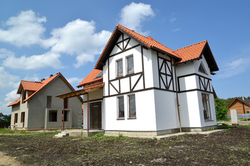 Construction of cottages in the settlement. Stylization of half-timbered style