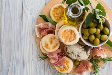 Crescentina modenese or tigelle ,  round breads from the Apennines, Modena area of Emilia-Romagna, Northern Italy, with cunza, a spread made from pork lard and flavoured with garlic and rosemary