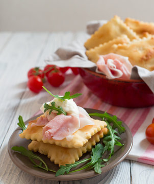 Gnocco fritto or Crescentina   is a bread in Italian cuisine from the Emilia region of Italy accompanied with cheese squacquerone and prosciutto.