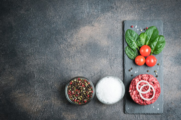 Mince. Shredded meat with ingredients fresh vegetables and spices for cooking on a black background. Top view copy space.
