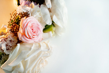 Bouquet of white roses lying on the white table. Closeup, copy space.