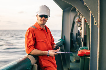 Marine Deck Officer or Chief mate on deck of offshore vessel or ship , wearing PPE personal...