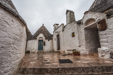 Detail of  Trulli of Alberobello in a small square on a rainy day