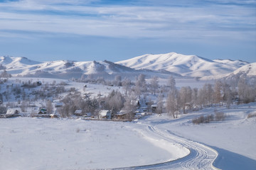 Fototapeta na wymiar Siberian village in the mountains in winter, Altai Mountains, Siberia, Russia