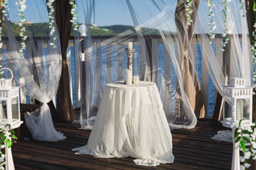 Table with a candlestick in the gazebo at the pier