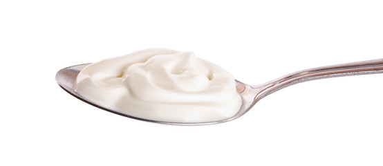 Sour cream in metal spoon isolated on white background