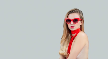Blonde woman with long hair and red lips in sunglasses