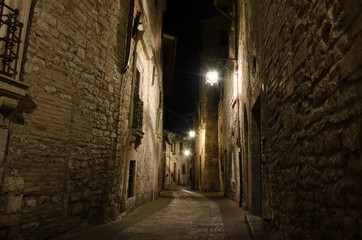 Fototapeta na wymiar Medieval old street in Assisi by night, Umbria, central Italy