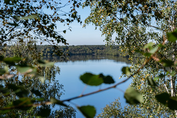  Nature and landscape concept: View of the lake from the hill, among the birch forest on the background of blue sky.Lake Mare &agrave; Goriaux,Nord-Pas-de-Calais,France. 