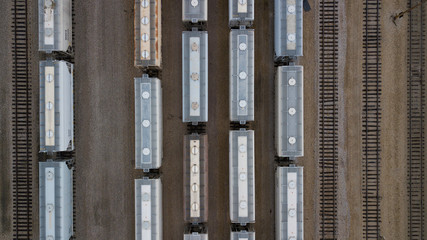 Aerial view of freight trains. Rail cars with goods on railroad. Top view of colorful freight train on the railway station. Heavy industry. Industrial landscape vertical 