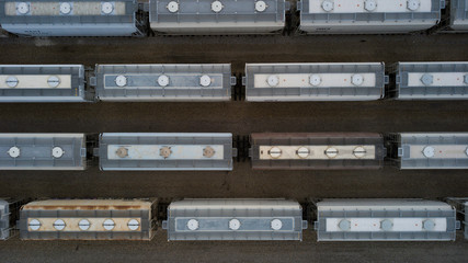 Aerial view of freight trains. Rail cars with goods on railroad. Top view of colorful freight train...