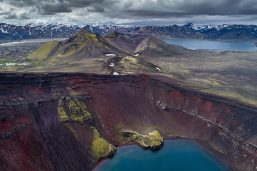 Iceland - Landmannalaugar - Aerial view of red lava rock volcano and crater lake in Volcano area Ljótipollur