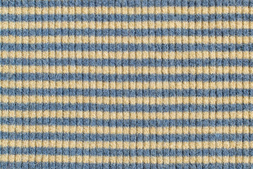 Surface of the knitted fabric of natural wool with yellow and blue stripes close-up. Texture for...