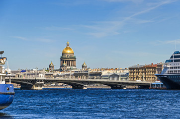 Saint Isaac's Cathedral behind the Blagoveshchenskiy bridge and Neva River with the cruise liner Azamara