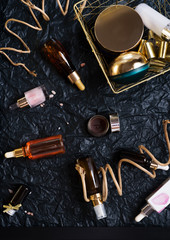 set of nature precious oils and  care cosmetics on black background .