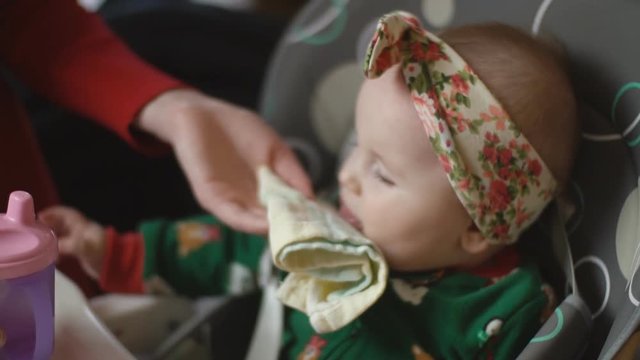 the little girl is drinking from the trough