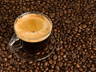 Cup of coffee on scattering of coffee beans