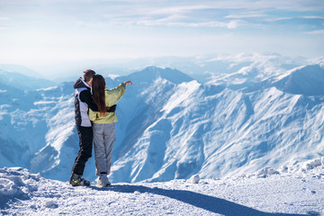 Fototapeta na wymiar Couple with ski equipment spending winter vacation in mountains