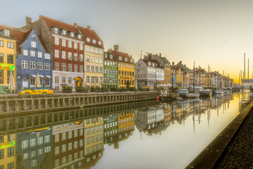 Morning has broken over the scenic houses on the quay of Nyhavn Canal