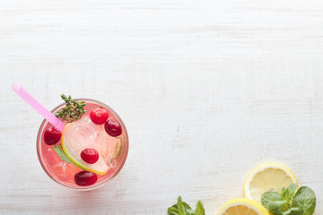 In summer, drink berry lemonade cocktail with lemon and ice in a glass. Ice-cold lemonade. Healthy vitamin drink. Copy space. the view from the top.