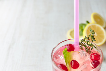 In summer, drink berry lemonade cocktail with lemon and ice in a glass. Ice-cold lemonade. Healthy vitamin drink. Copy space. the view from the top.