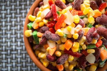 Homemade mixture of frozen vegetables, carrot, paprika, beans, green beans, onion and corn with copy space
