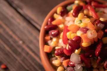 Homemade mixture of frozen vegetables, carrot, paprika, beans, green beans, onion and corn with copy space