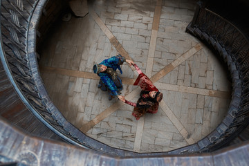 Middle eastern Women dancing in the middle of old wooden stairs