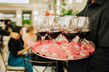 waiter serving glasses of wine