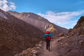 Fototapeta premium Hiker girl on the tourist path in High Atlas mountains in Jebel Toubkal region Morocco Africa