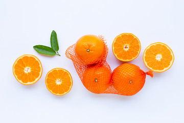 High vitamin C. Orange in net bag with ripe half of orange on white