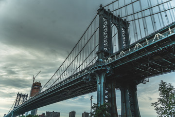 Manhattan bridge seeing from below with great sky in the background