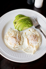 Two eggs over medium with avocado