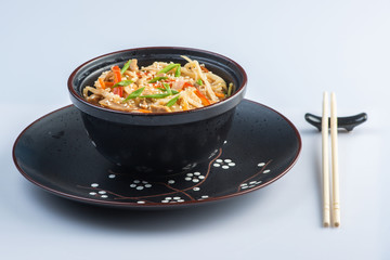 Japanese ramen soup with chicken, egg, chives and sprout on dark wooden background.
