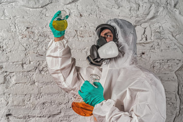 male researcher analyzing liquid reagent in laboratory glassware