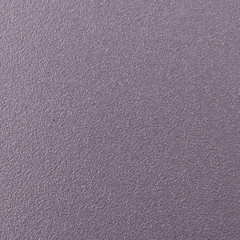 Background texture of a shiny metal sheet with a rough stippled textured surface reflecting light. Metal texture