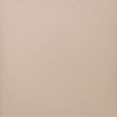 Background texture of a shiny metal sheet with a rough stippled textured surface reflecting light. Metal texture