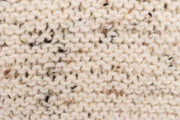Winter Sweater Design. Bege knitting wool texture background. knitted fabric texture. Knitted jersey background with a relief pattern. Braids in knitting.