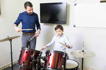 Tutor Enlightening His Student With Knowledge Of Drums