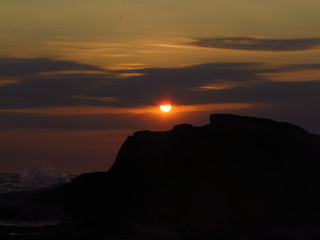 Sunset with rocks by the beach