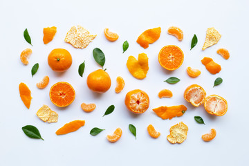 Orange fruits and green leaves on a white background.