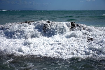Waves crashing over ocean rocks background